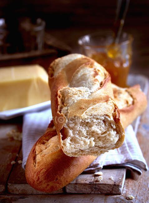 A fresh baguette with butter and jam — Stock Photo