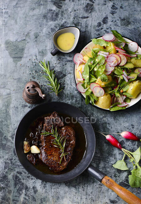 Steak with potato salad, top view — Stock Photo
