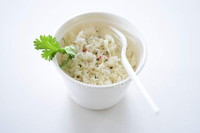 Rice with pepper and parsley in takeaway pot — Stock Photo