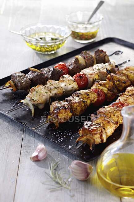 Grilled meat, vegetables and sauces on table. — Stock Photo