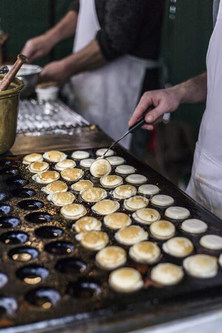 Poffertjes, small pancakes on pan — Stock Photo