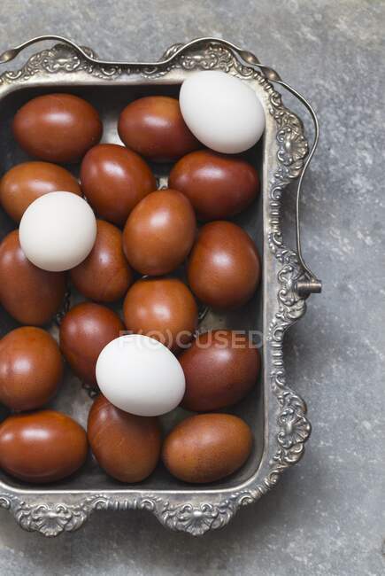 White and brown eggs in vintage silver tray — Stock Photo