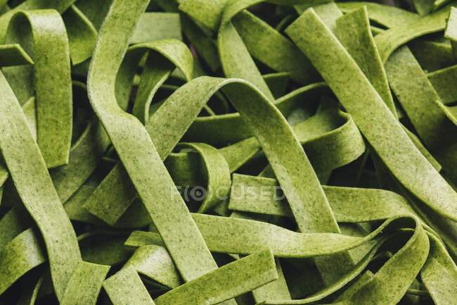 Green ribbon noodles, closeup shot — Stock Photo