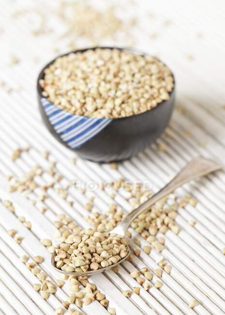 Buckwheat in small bowls and on a spoon — Stock Photo