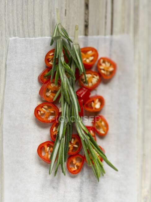 Chilli rings and fresh rosemary (top view) — Stock Photo