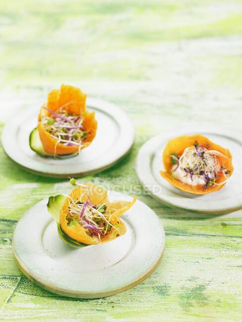 Plan rapproché de délicieuses salades de pousses comestibles dans des bols à carottes — Photo de stock