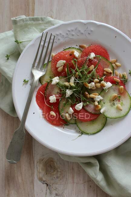 Cucumber and melon carpaccio with pine nuts — Stock Photo