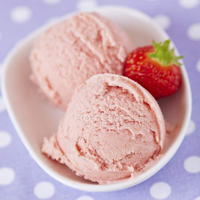 Two scoops of home-made strawberry ice cream with a fresh strawberry, viewed from above — Stock Photo