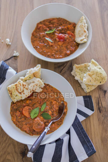 Lentil curry with coconut in two plates, served with naan bread — Stock Photo