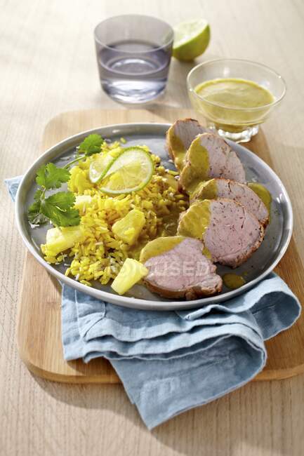 Pork fillet with pineapple rice and coriander leaves — Stock Photo