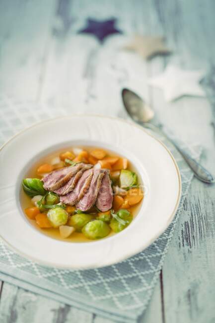 Poultry consomme with carrots and brussels sprouts (Christmas) — Stock Photo