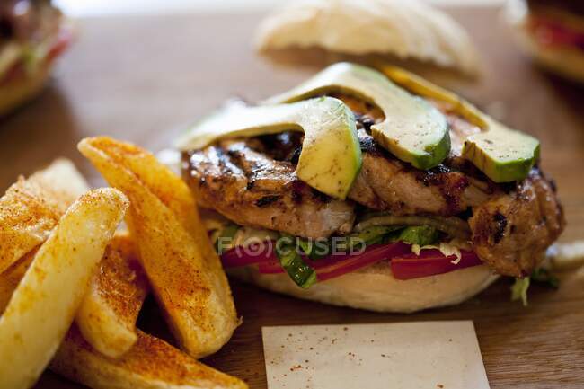 Chicken and Avocado Prego Roll with potato wedges — Stock Photo