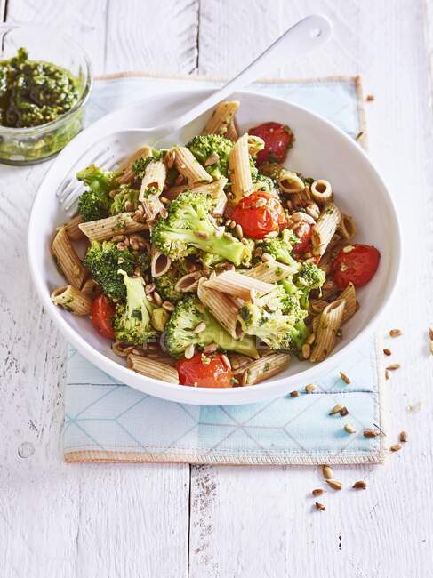 Wholewheat pasta with broccoli, tomatoes and sunflower pesto — Stock Photo