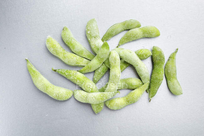 Frozen edamame on a grey background (top view) — Stock Photo