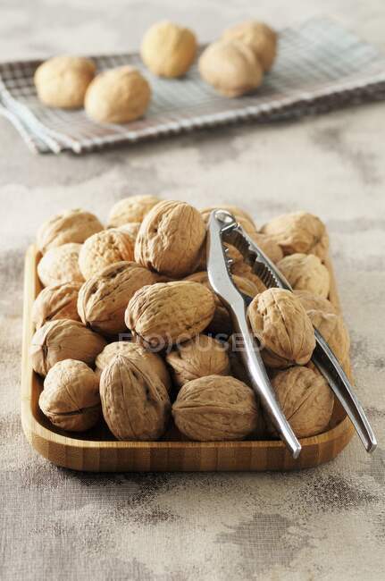 Whole Walnuts with Nut Crackers — Stock Photo