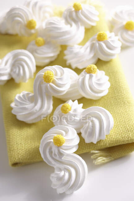 Delicate meringues with yellow sugar decorations — Stock Photo