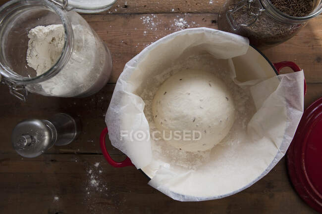 Sourdough rising with flour and herbs — Stock Photo
