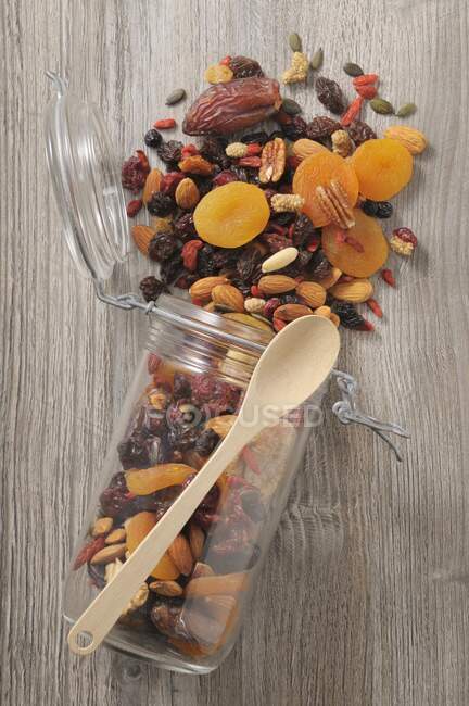 Dried fruit and nuts in storage jar — Stock Photo