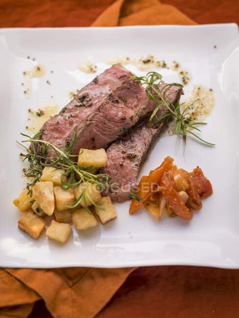 A beef steak with herb butter and vegetables — Stock Photo