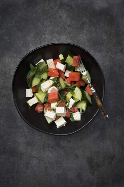 Watermelon salad with feta cheese, cucumbers, mint and lime dressing — Stock Photo