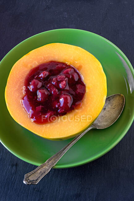 Papaya filled with cherry porridge — Stock Photo