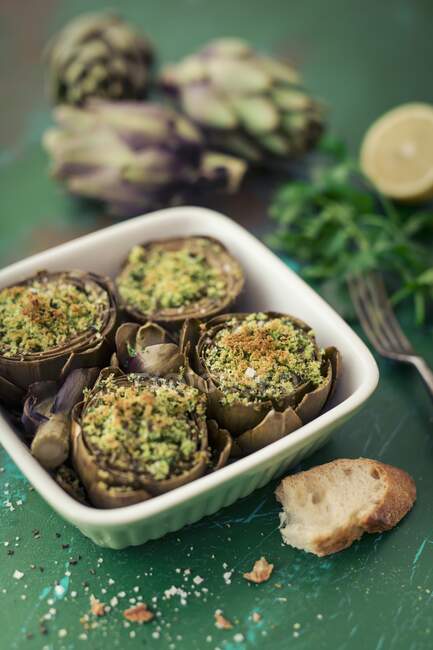 Artichokes with a herb filling — Stock Photo