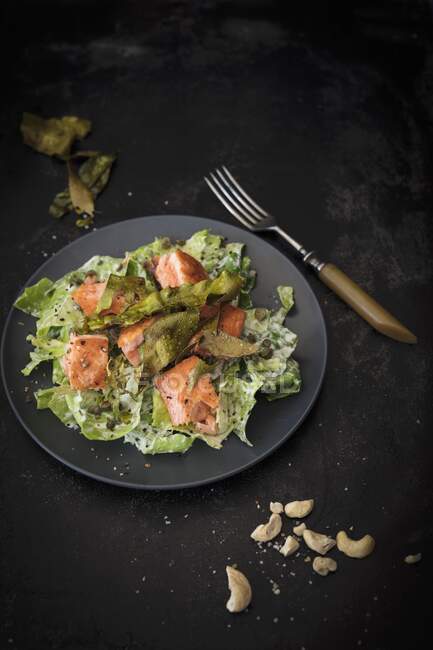 Caesar salad with crisp algae bacon and salmon — Stock Photo