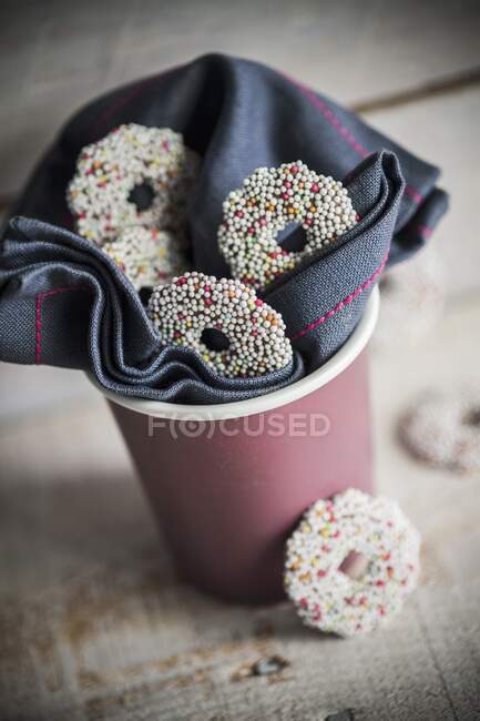 Chocolate biscuits fully covered in colourful sugar beads — Stock Photo