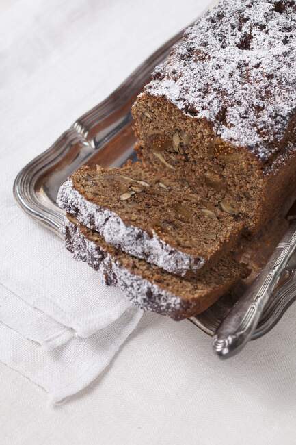 Figs and walnuts bread on metal tin with knife — Stock Photo