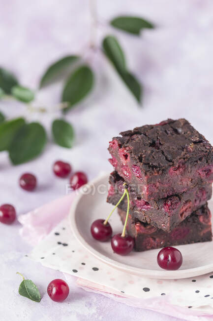 Cherry brownies on white plate — Stock Photo