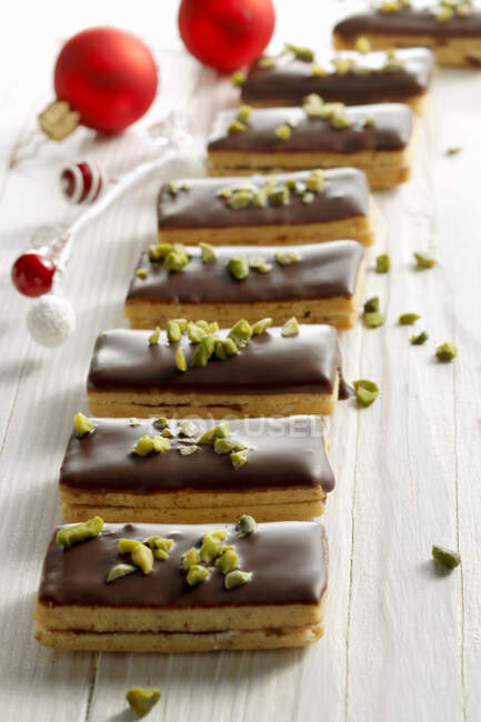 Ischler slices with dark chocolate and pistachios — Stock Photo