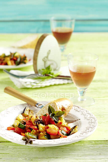 Warm aubergines salad with peppers, tomatoes, zucchini and baguettes for Easter — Stock Photo