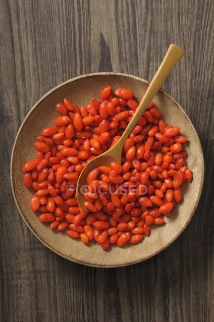 Goji berries in wooden bowl with spoon — Stock Photo