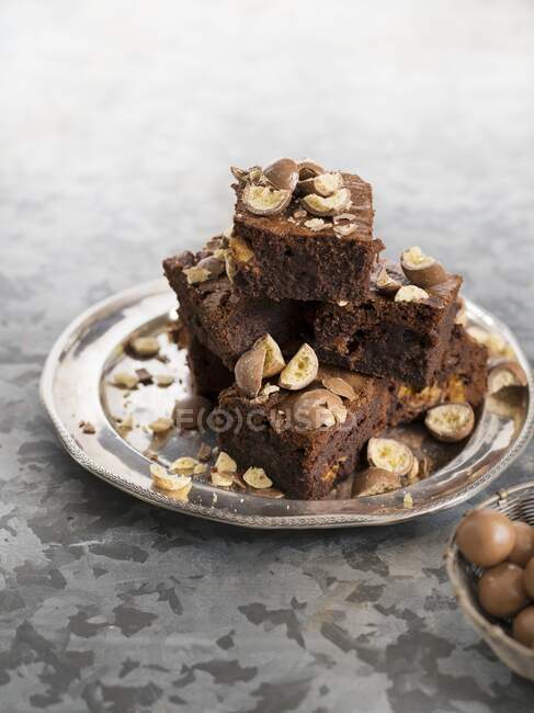 Brownies with Maltesers on iron plate — Stock Photo