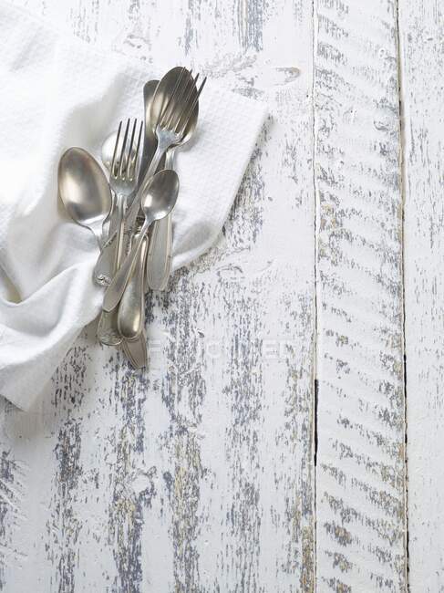 Old silver cutlery on a napkin — Stock Photo