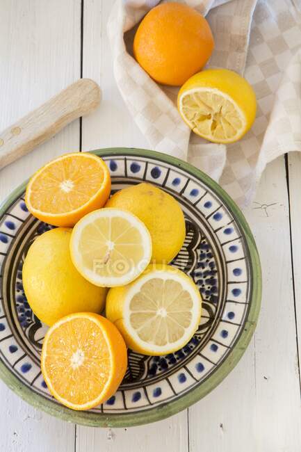 Limoni e arance su un piatto di ceramica — Foto stock