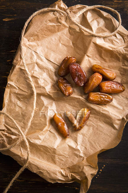 Close-up shot of delicious Date on a piece of paper — Stock Photo