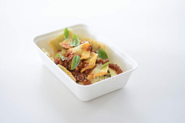 Ravioli with bolognese in a takeaway box — Stock Photo