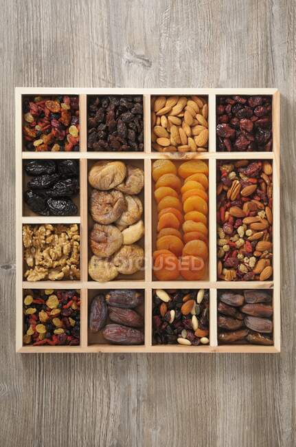 Various dried fruit and nuts in a case — Stock Photo