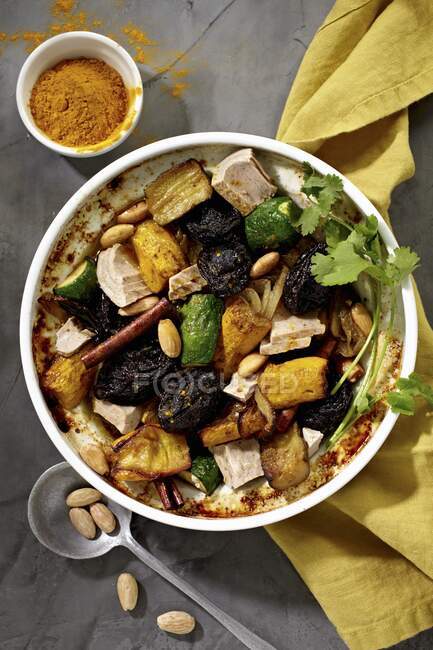 Tuna fish tagine with eggplants, fruit, almonds and spices — Stock Photo
