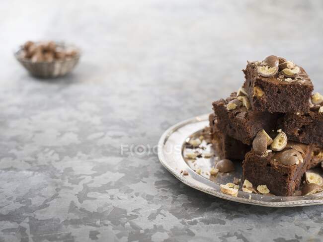 Brownies with Maltesers on iron plate — Stock Photo