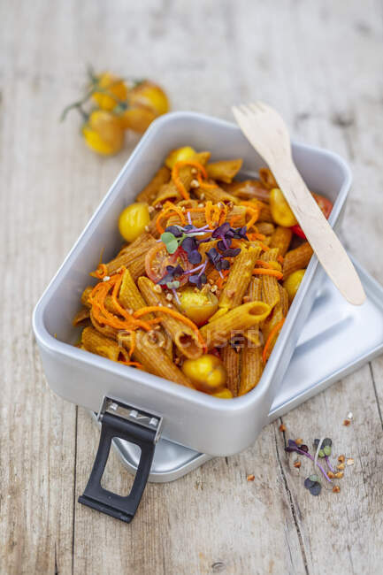 Red lentil pasta with turmeric, cherry tomatoes, carrots and buckwheat — Stock Photo