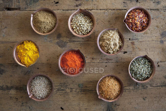Assorted spices in copper bowls — Stock Photo