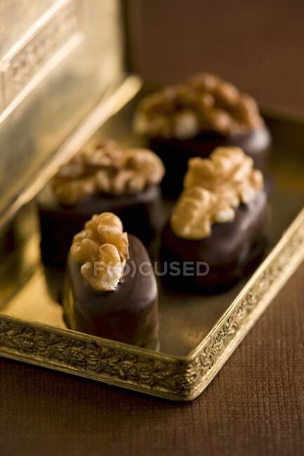 Pralines with walnut kernels — Stock Photo