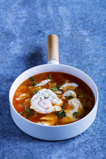 Cod soup with poached eggs — Stock Photo
