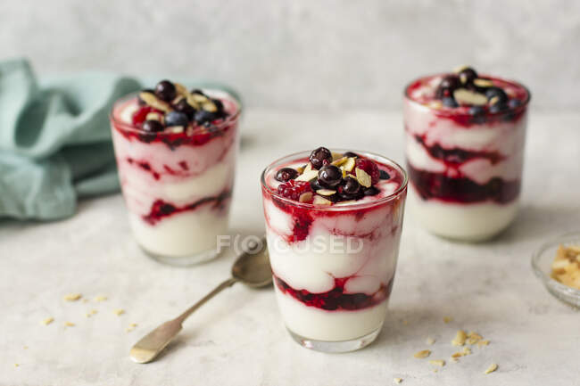 Yogurt with honey, berries and almond flakes — Stock Photo