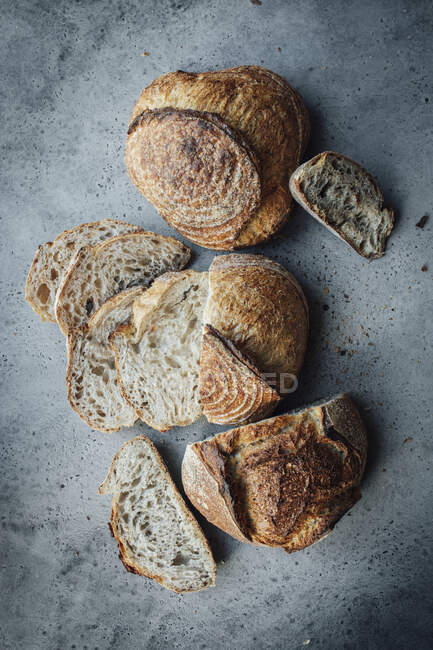 Anordnung von Brot mit Brotscheiben auf grauer Fläche — Stockfoto