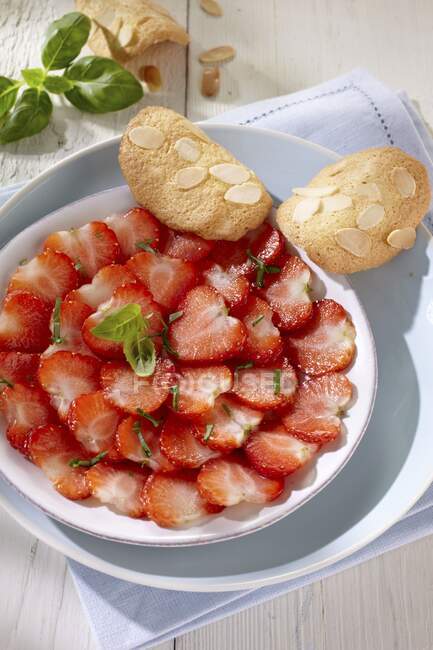 Strawberries carpaccio with mint and almond pastries — Stock Photo