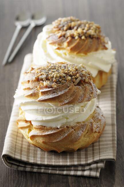 Profiteroles with cream and nuts — Stock Photo