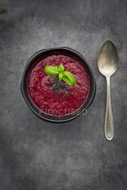 Beetroot soup with basil and black nuts — Stock Photo